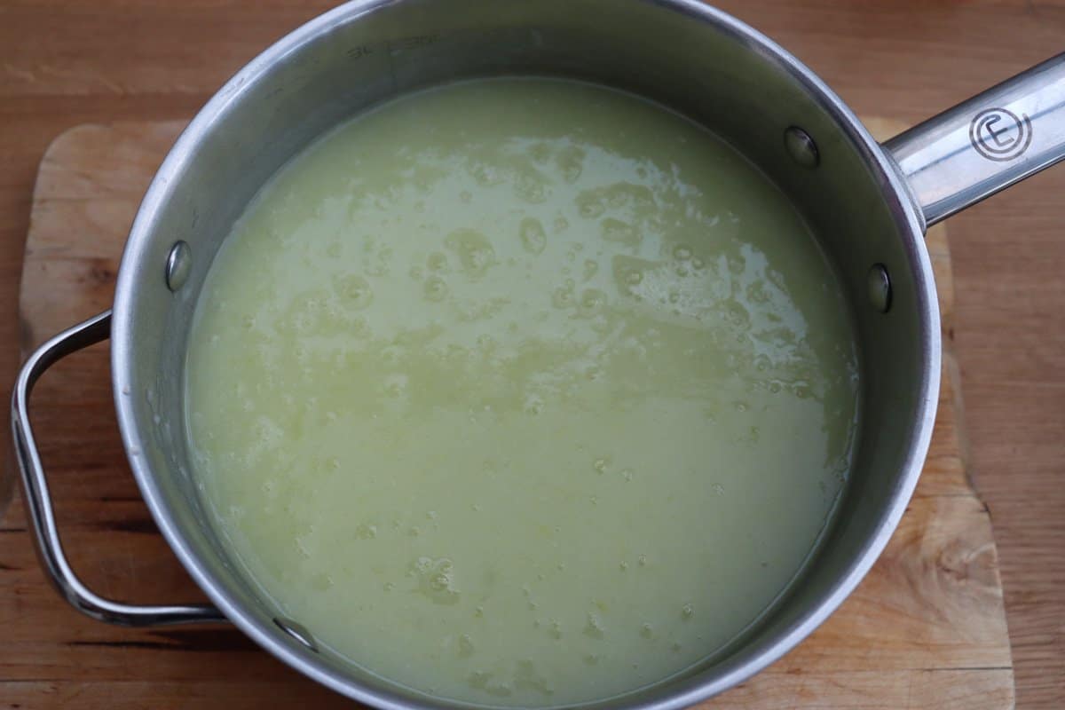 Leek and potato soup in a saucepan.