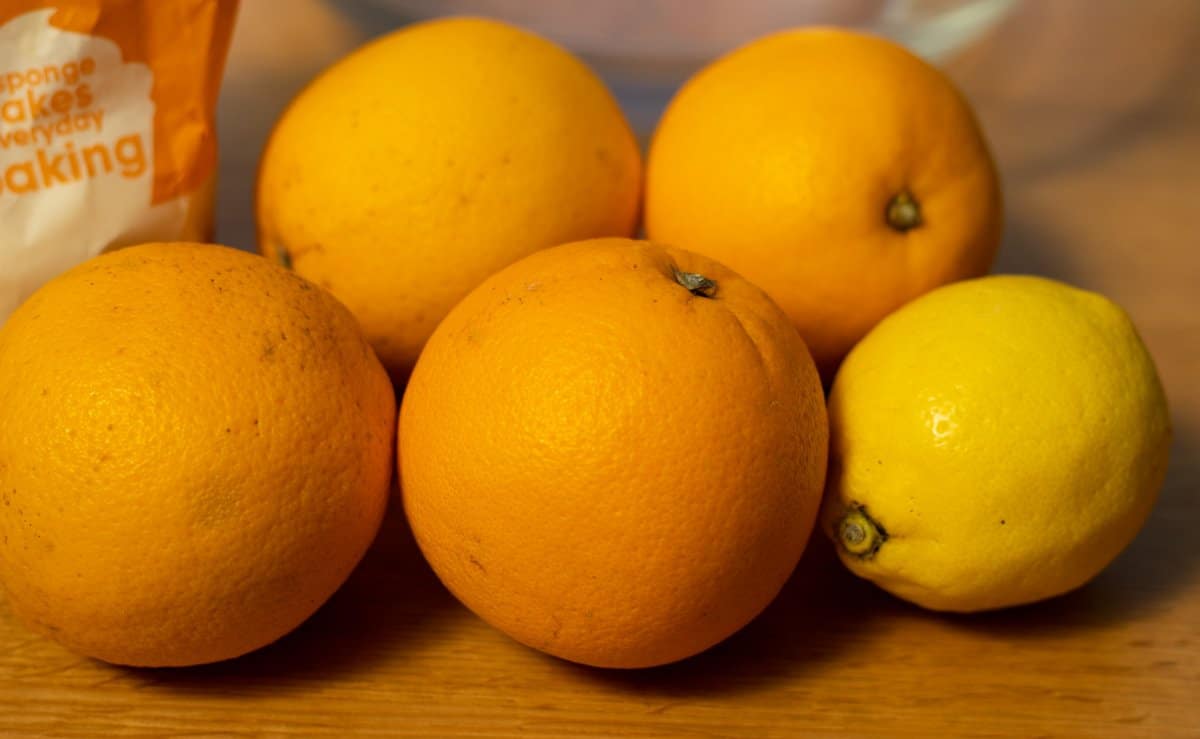 oranges and lemon with packet of sugar