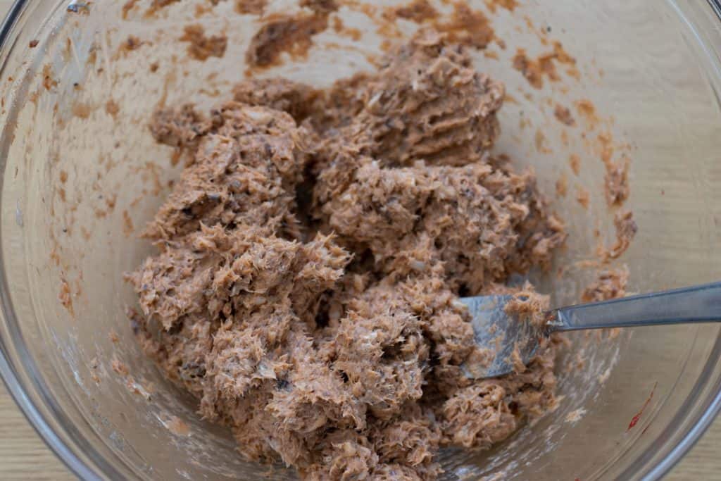 mashed sardine mixture in glass bowl with fork using for mashing