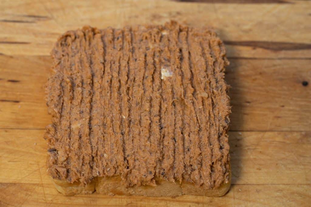 a slice of toast spread with sardine mixture before toasting