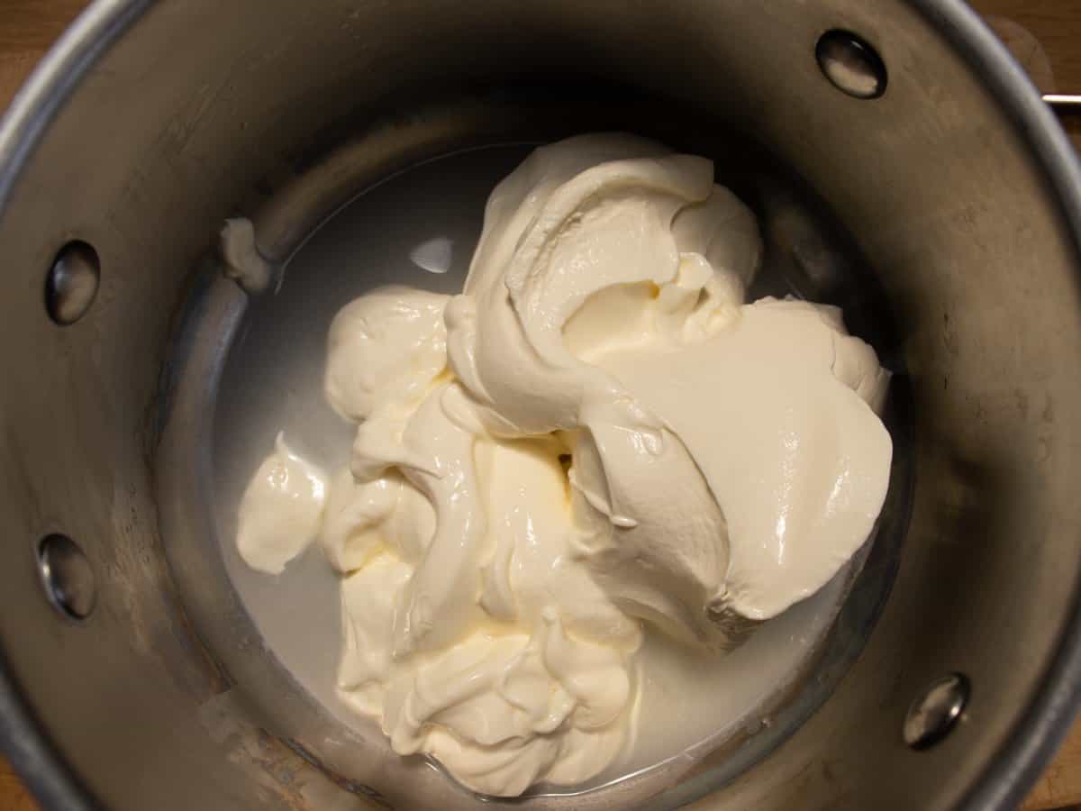 Smoked salmon and creme fraiche in a saucepan.