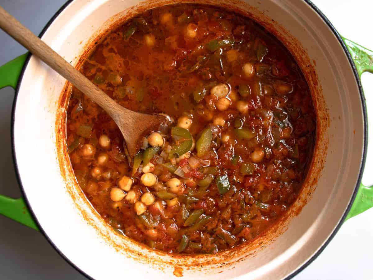 Chickpea and tomato soup with peppers in enamelled saucepan.
