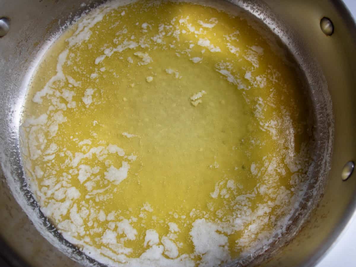 Melted butter in a stainless steel saucepan.