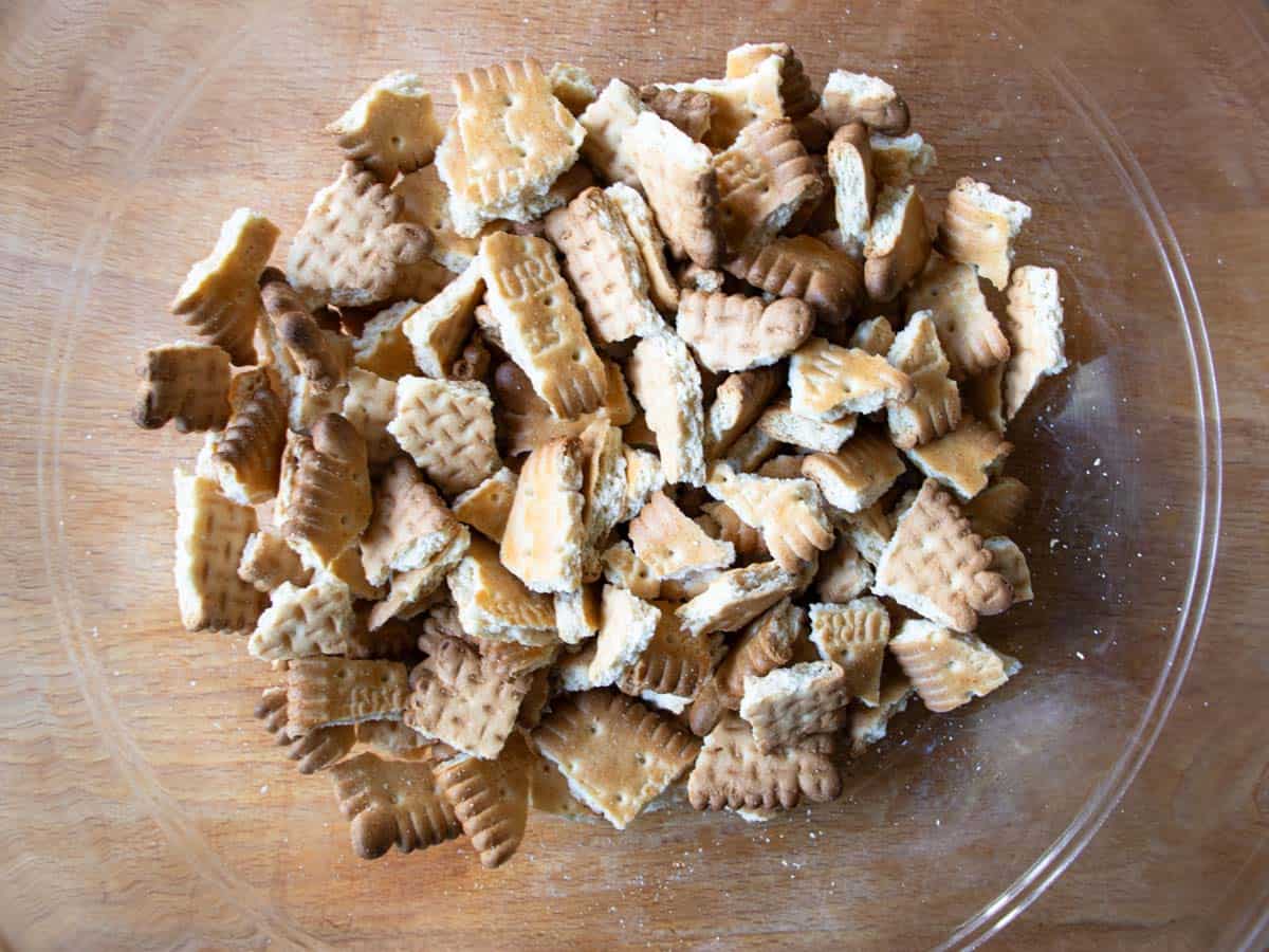Broken pieces of Petit Beurre biscuits in glass mixing bowl.