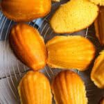 Several French lemon Madeleines on wire tray.